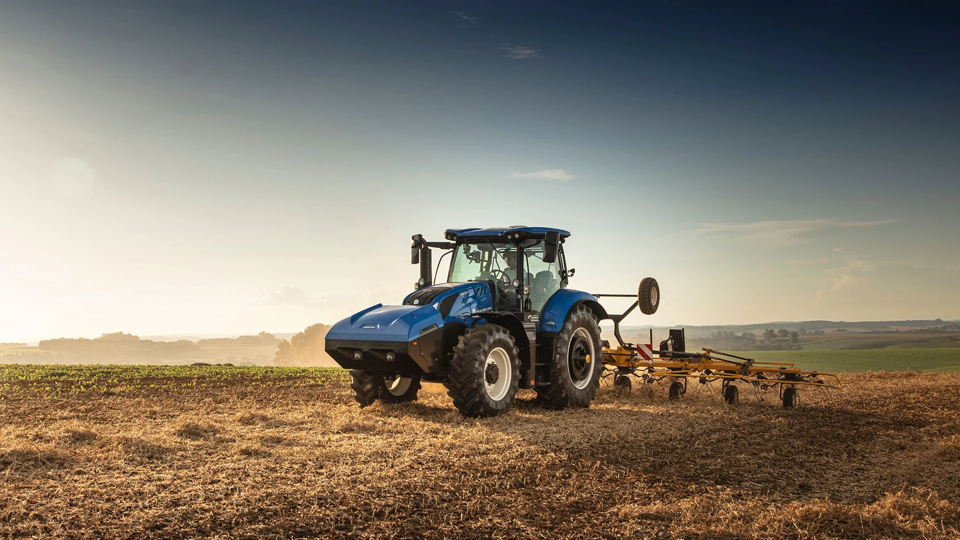Fotografia da linha T6 Methane Power em campo; configuração ilustrativa para New Holland T6.180